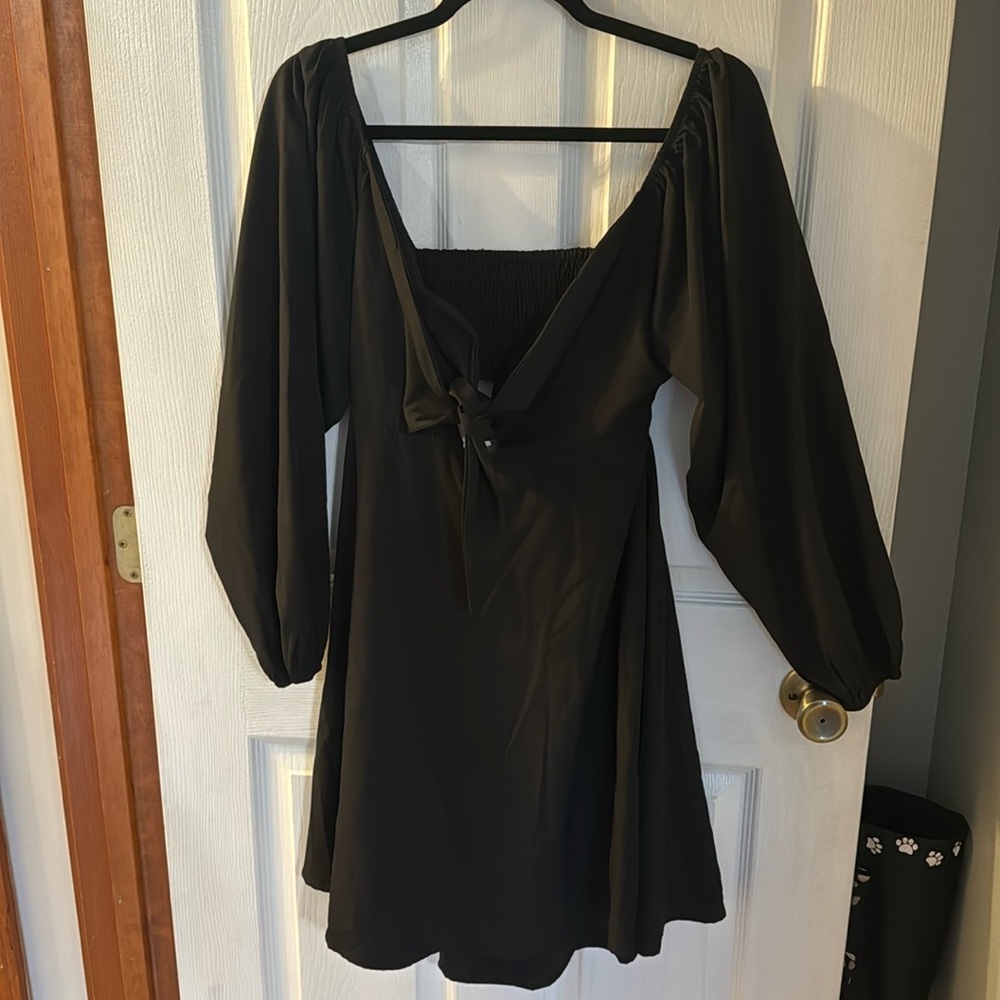 Black dress, ties in front, and cut out in back.  Elastic on sleeves